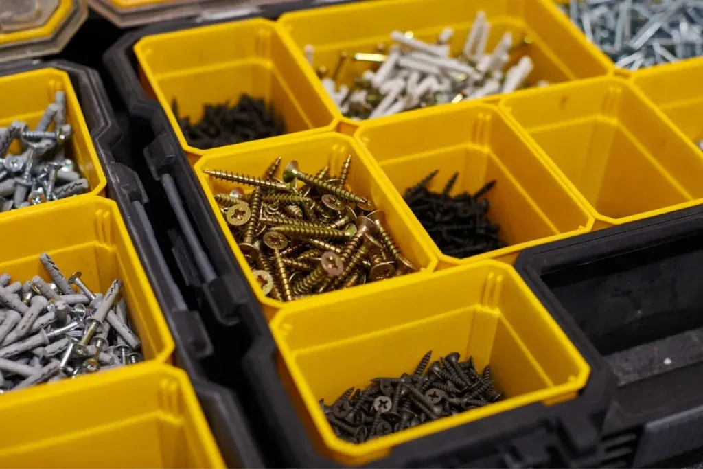Yellow organizer box filled with sorted screws and fasteners